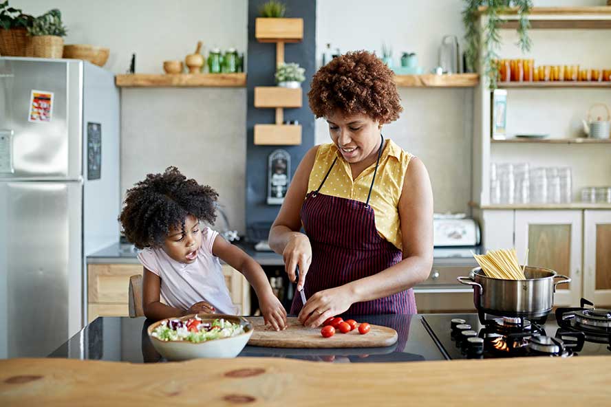 family-cooking A woman and child cooking in a kitchen